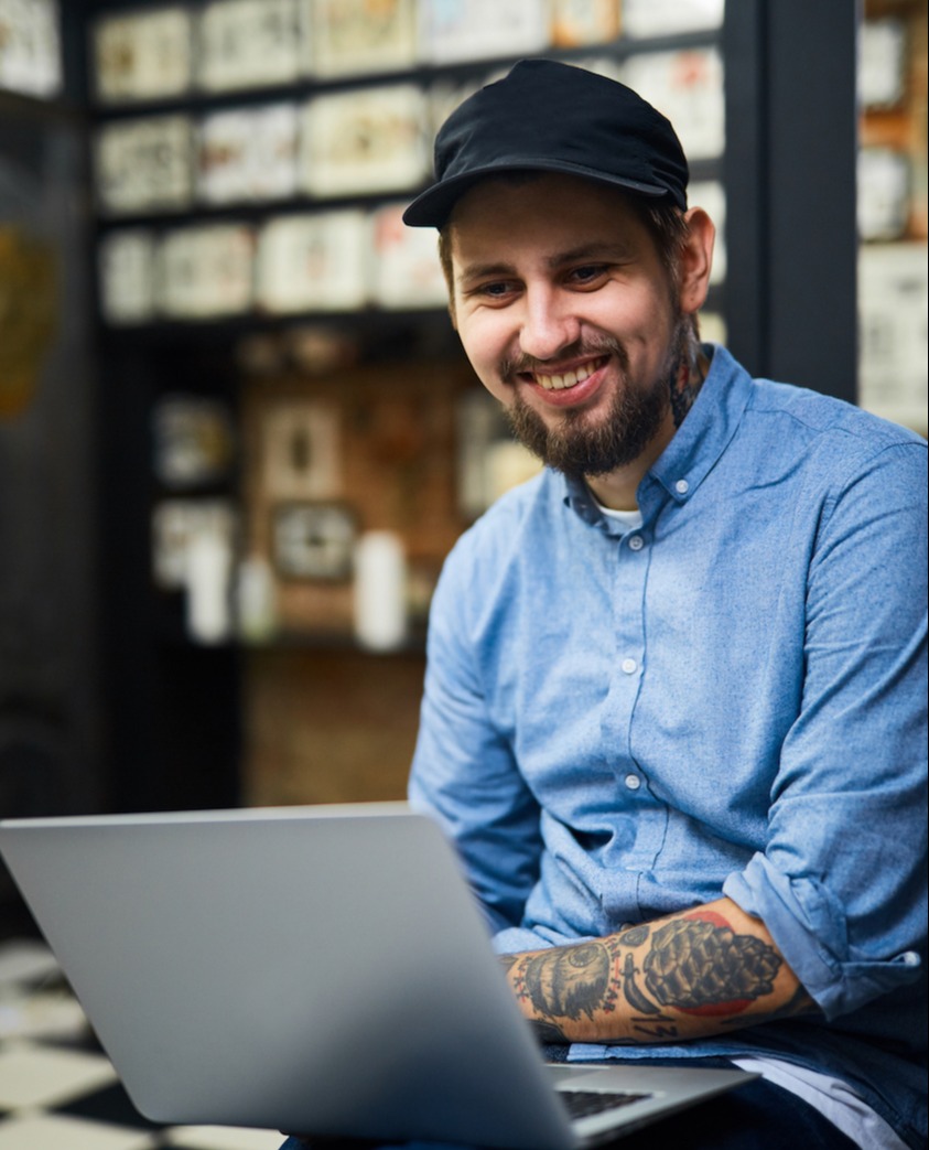 happy-tattooist-with-laptop-working-in-the-net-SBI-324036251-1-1