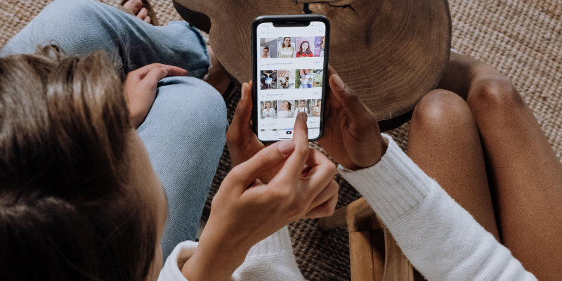 Two women looking at photos on social media.